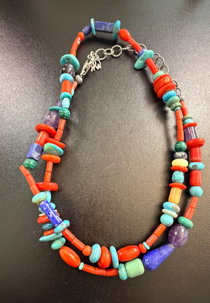 Colorful multi-strand beaded necklace with red, turquoise-colored, blue, purple and green beads