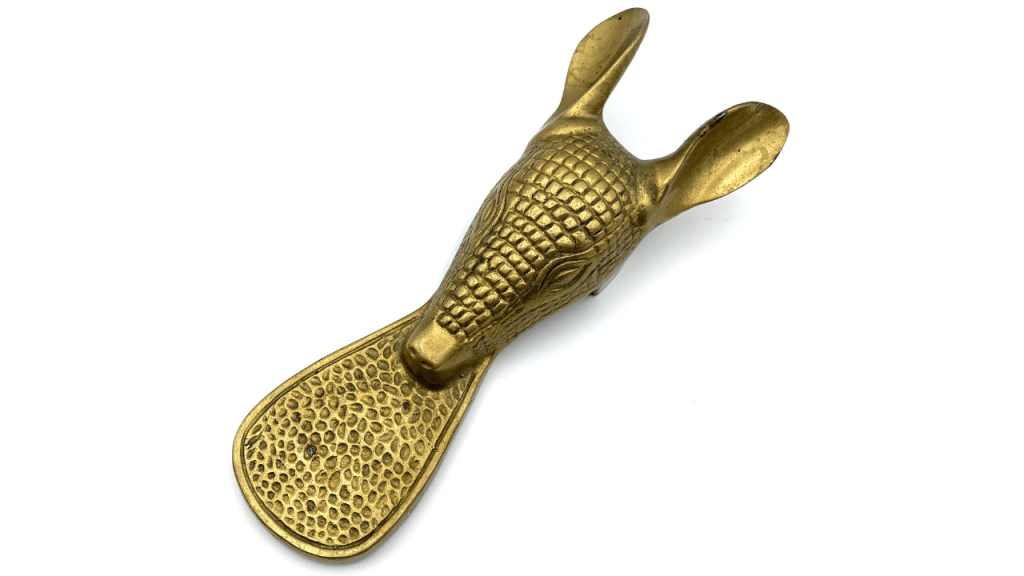 Vintage brass animal-head shoehorn with textured handle